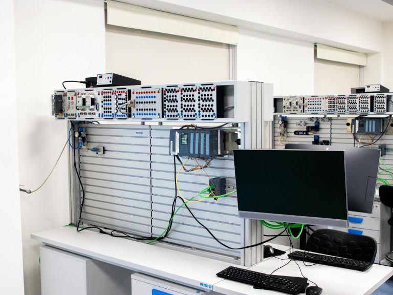 A contemporary office showcasing a server rack and computer workspace, ideal for tech and business settings.